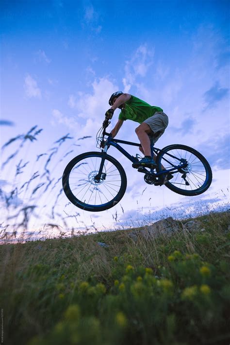 Caucasian Man Jumping With Mountain Bike Off Road By Stocksy Contributor Ibex Media Stocksy