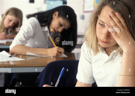 Secondary School Girl Struggling In Classroom Test Or Exam Stock Photo