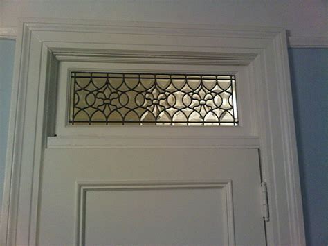 A transom window is the entire window structure installed above the door. All Custom Beveled Fleur de Lis Transom Window
