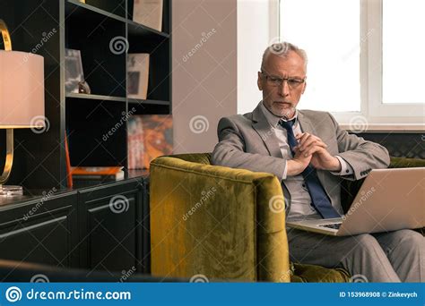 Thoughtful Caucasian Stylish Senior Man Sitting In His Office Stock