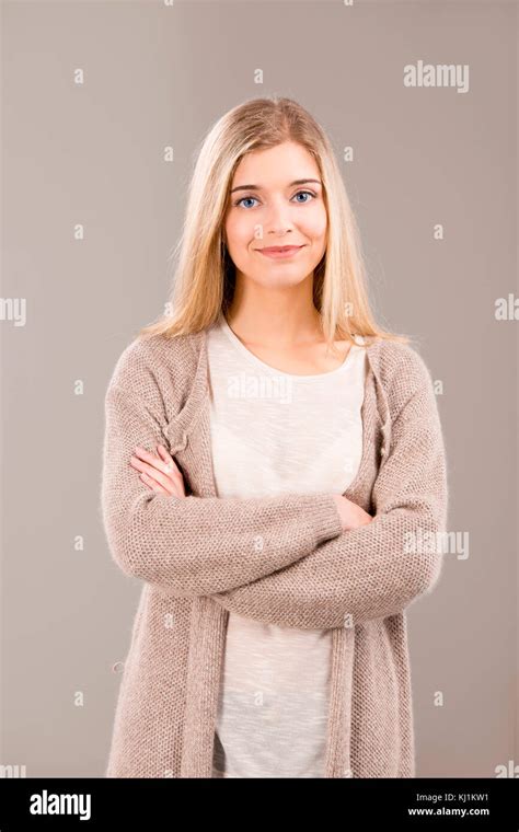 Beautiful Blonde Woman Smiling And Standing With Hands Folded Stock