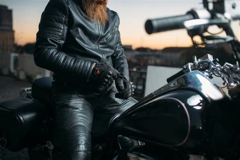 Premium Photo Biker Poses On A Motorcycle In City On Sunset