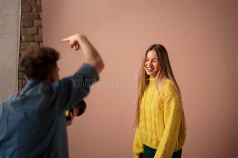 Young Photographer Taking Picures Of Model Backstage Of Photoshooting