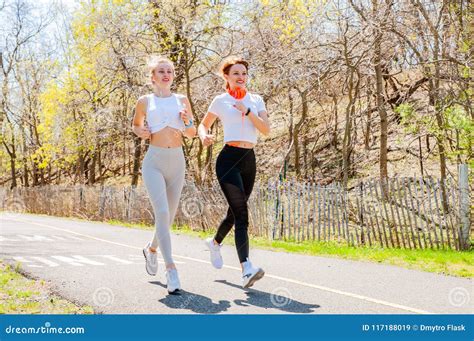 Two Happy Sporty Girls Running In The Park Stock Image Image Of Lifestyle Scene 117188019