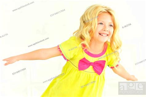 Portrait Of Cute Little Girl Posing In Bright Dress Stock Photo