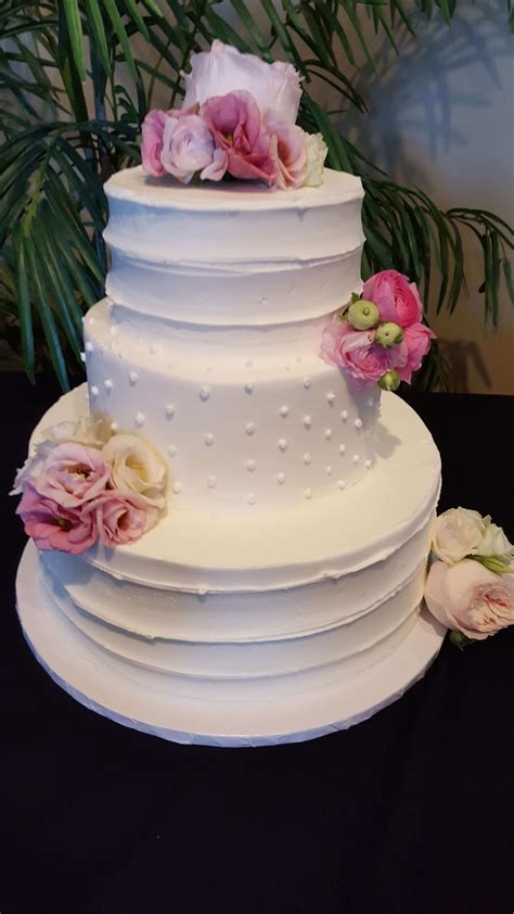 flowers on layered wedding cake wedding cakes minneapolis bakery farmington bakery