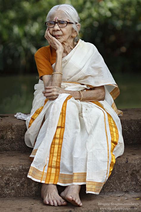 An Old Woman Sitting On Steps With Her Hand Under Her Chin