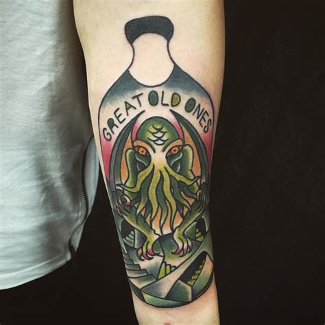 Green Ink Cthulhu Tattoo On Left Forearm