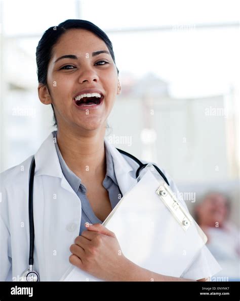 Laughing Doctor Holding A Medical Clipboard Stock Photo Alamy