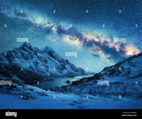 Milky Way Over Snow Covered Mountains And Sea Coast At Night In Winter