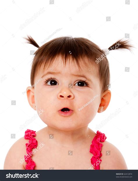 Face Of Cute Surprised Baby Infant Girl With Ponytails Making Funny