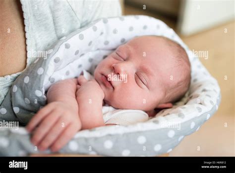 Unrecognizable Mother Holding Newborn Baby Son In Her Arms Stock Photo