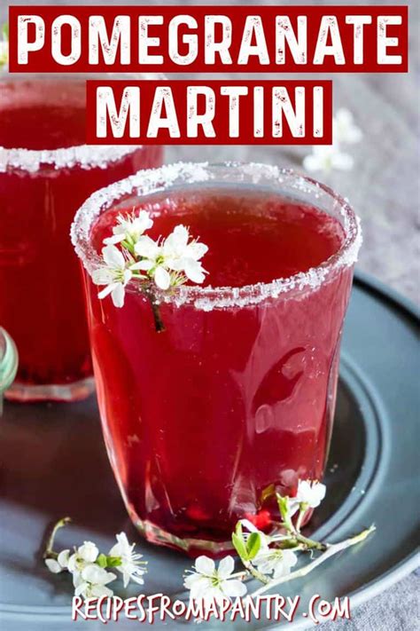 homemade pomegranate martini recipe on a black plate with flowers and text overlay