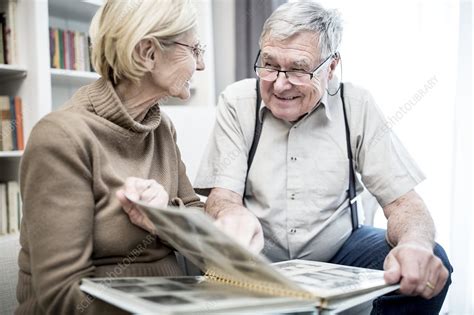 senior couple looking at photo album stock image f021 6765 science photo library