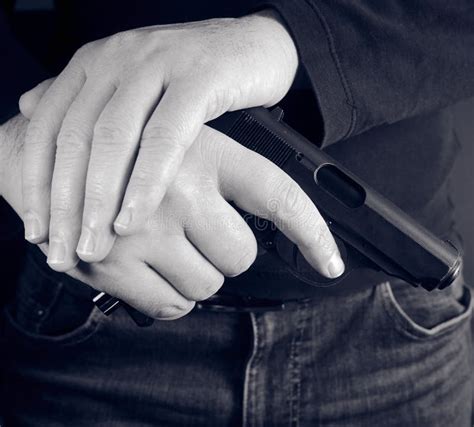 Cropped Shot Of Man Holding Gun In Hand Stock Photo Image Of Holding