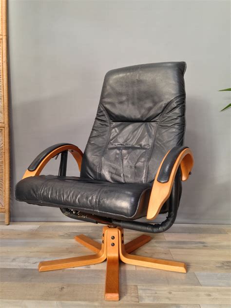 Shop our best selection of leather chairs to reflect your style and inspire your home. Vintage armchair in leather and wood with ottoman by Unico ...