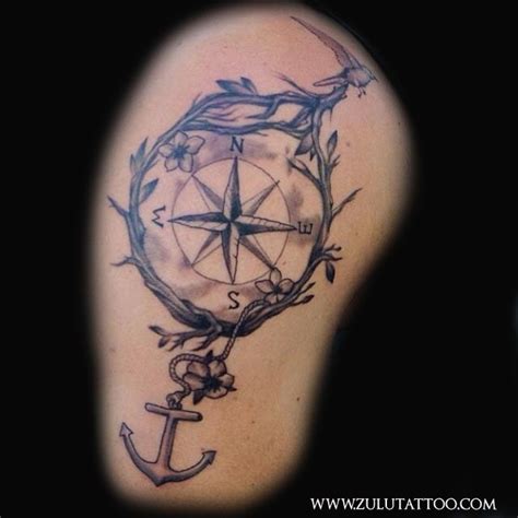 An Anchor And Compass Tattoo On The Arm