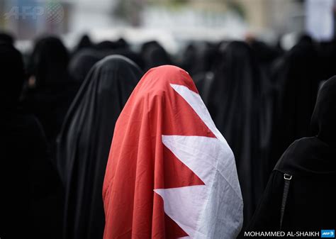 bahrain north sehla a bahraini woman wears a national flag during the funeral of sadeq sabt