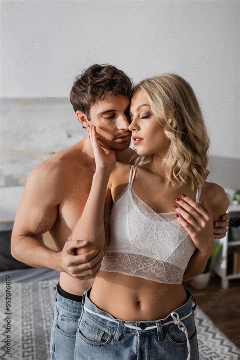 Sexy Woman In Bra Touching Muscular Boyfriend In Bedroom Stock Photo Adobe Stock