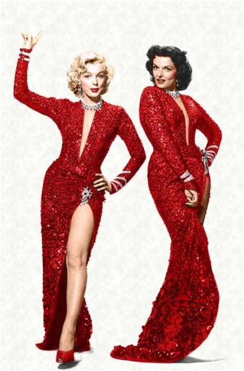 Two Women In Red Sequin Dresses With One Holding Her Hand Up To The Side