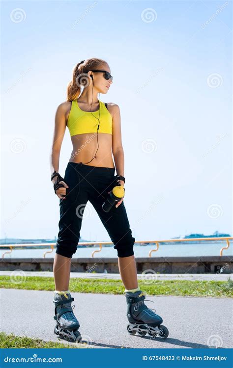 Young Beautiful Sporty And Fit Girl Rollerblading On Inline Skates
