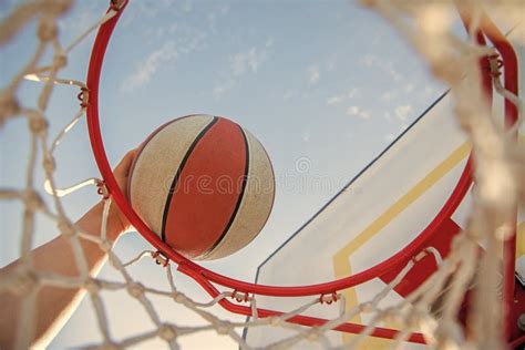 Basketball Ball Flying Through Basket In Players Hands Closeup Sport