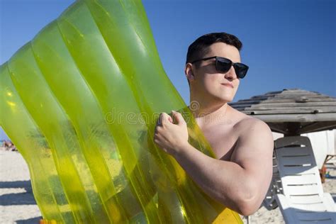 Men On The Beach Near The Sea With Swimming Mattress Stock Image