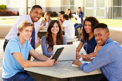 High School Students Working On Campus With Teacher Stock Photo Image