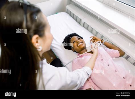 Ultrasound Examination Of The Neck In The Clinic Woman Doctor Conducts