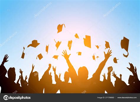 Happy Students Throwing Graduation Caps In The Air Stock Photo By