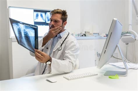 Serious Attractive Doctor Examining An X Ray Stock Image Image Of