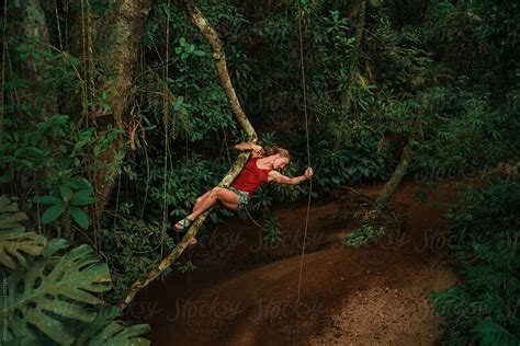 Woman Swings From Vine In Jungle By Howl