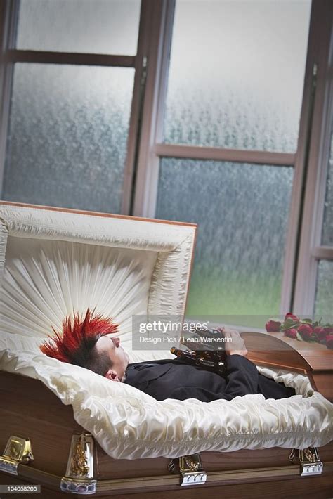 A Deceased Young Man In A Coffin Holding Beer Bottles High Res Stock