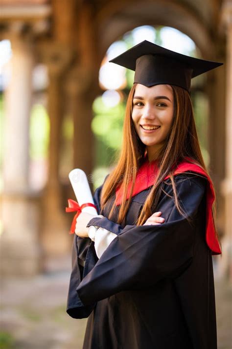 Young Happy Woman Portrait On Her Graduation Day Holding Diploma At