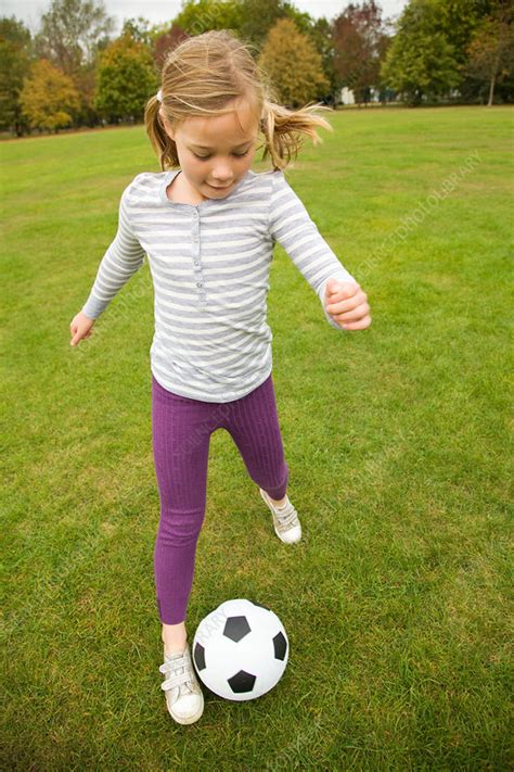 Girl Playing With Soccer Ball In Field Stock Image F0054667
