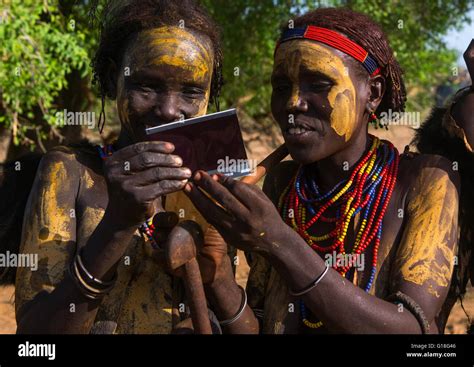 Dassanech Tribe Women Looking Polaroid Pictures Of Themselves Omo