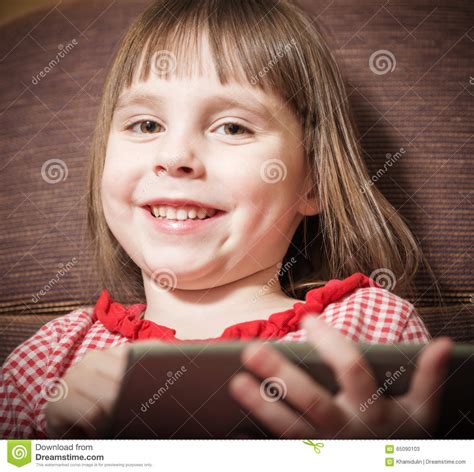 Little Girl Playing With A Modern Digital Tablet Stock Image Image Of