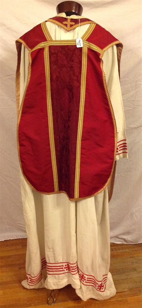 white alb priest garment and red chasuble and stole · mckay library special collections