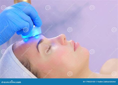 Cosmetologist Doctor Making Phonophoresis Procedure On Woman Face Side