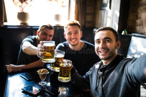 Happy Male Friends Drinking Beer And Taking Selfie With Smartphone At Bar Or Pub Stock Image