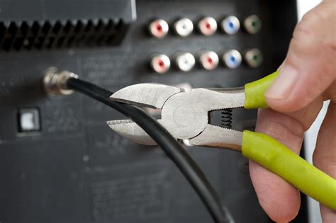 Cut The Cable Tv Cord With Hand And Wire Cutters Deg
