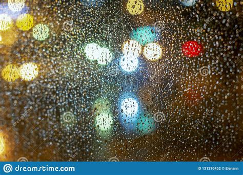 Bokeh Blurs Colored Lights On Glass With Drops From Autumn Rain Stock