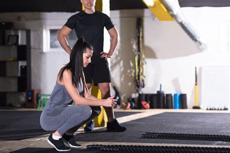 Premium Photo Young Fit Sports Couple Working Out In Functional