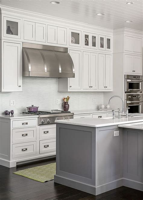 We're sharing some of our favorite kitchens and their cabinet paint colors to help you achieve a clean and beautiful look. Timber Wolf Benjamin Moore Grey island paint color Plain ...
