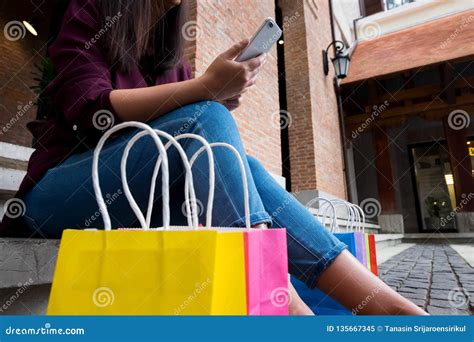 Woman Using Smartphone For Shopping Online In Shopping Mall Stock Image