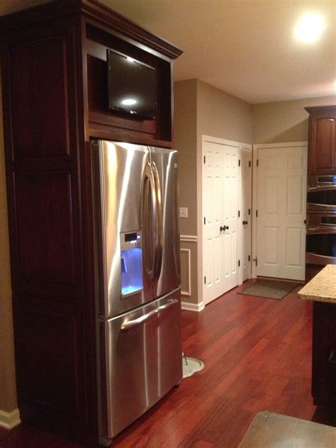 An under cabinet tv is a television specifically designed to hang underneath a kitchen cabinet. TV mounted above refrigerator on a cabinet door that is ...