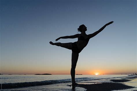 Girl Dancing Standing On Her Leg On The Seashore At Sunset By Luis