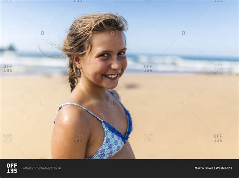 Portrait Of Smiling Girl Wearing Bikini Top On The Beach Stock Photo OFFSET