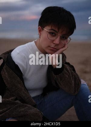 Tired Transsexual Woman Sitting On The Beach Holding Her Head With Her Arm Stock Photo Alamy