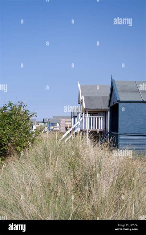 Uk Norfolk Coastline Beach Huts Sitting Among The Stand Dunes At Old